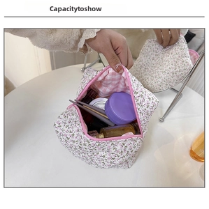 Detail showing high capacity floral makeup bag with pink zipper and soft cotton lining