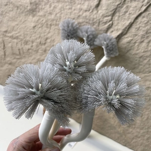 Détail des poils gris haute densité et du manche blanc courbé d'une brosse WC