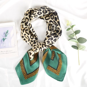 Green leopard print silk scarf for women featuring geometric patterns and a stylish knot