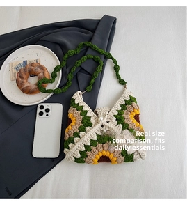 Detail view of handmade crochet sunflower tote bag showing size with phone and pearl clasp