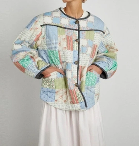 Detailed view of vintage quilted patchwork jacket with colorful floral and stripe patterns