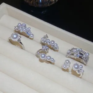 Elegant six-piece set of silver zircon and pearl open rings in a velvet jewelry box