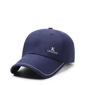 Detail of navy baseball cap featuring breathable side mesh and reflective brim accents