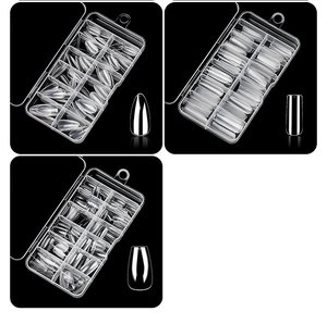 Macro shot of three shapes of clear nail tips in partitioned cases on black background