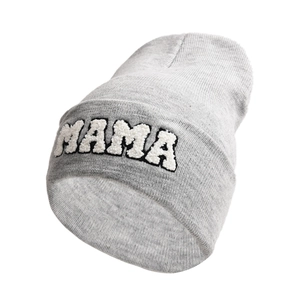 Close-up of light grey knit beanie featuring white chenille patch MAMA letter embroidery