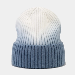 Detail of blue gradient tie-dye ribbed knit beanie with thick fold-over cuff design