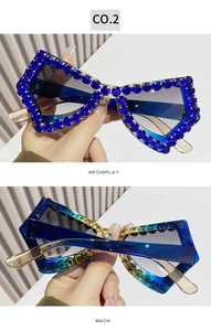 Macro detail of butterfly frame sunglasses with deep blue rhinestones and gradient lenses