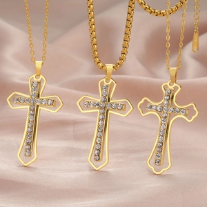 Gold stainless steel cross pendant necklace with clear zircon stones on pink satin