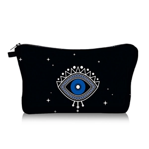 Detail of evil eye canvas makeup bag with durable black zipper and starburst print