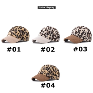 Detail view of four leopard print faux fur baseball caps with corduroy brims