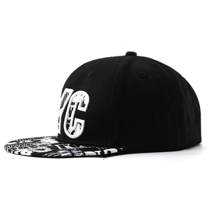 Detail view of NYC embroidered black snapback hat with printed brim and fabric texture