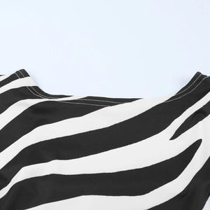 Close-up of zebra print fabric neckline with detailed stitching and high-quality finish