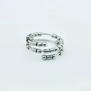 Detail view of silver stainless steel fidget beads on a triple-layer spiral spinning ring