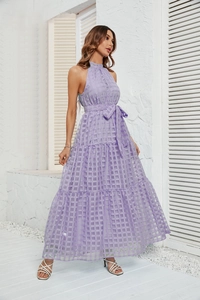 Detail of light purple halter neck maxi dress with tiered ruffle layers and waist bow