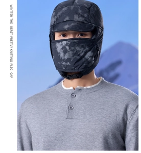Close-up of winter trapper hat with windproof mask and fleece lining in camouflage