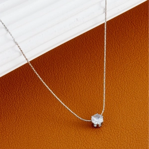 Minimalist silver necklace featuring a round zircon pendant with a classic snake chain