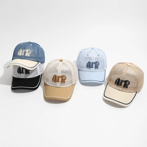 Flat lay detail showing five colors of breathable mesh baseball caps with AIR embroidery