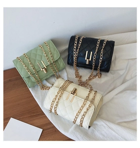 Detail of quilted leather crossbody bags in green, black, and beige with gold chains
