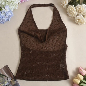 Detailed macro view of coffee knit mesh fabric with glittering silver sequins decor