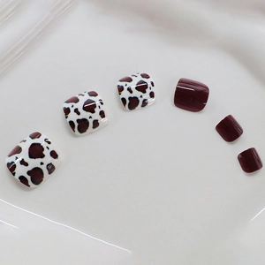 Chic burgundy and cow print press-on toenails in a stylish square shape design