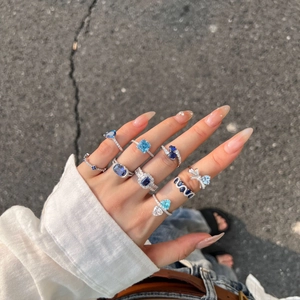Detail of S925 sterling silver rings with blue heart and icy cut zircon on hand