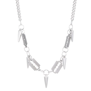 Close-up of hip-hop silver necklace with razor blade and cone pendants on white background
