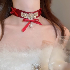 Close-up of red velvet choker with crystal squares and white drop pearl pendant