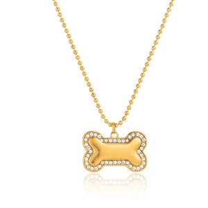 Close-up of 18K gold bone pendant with crystal border and polished metal center