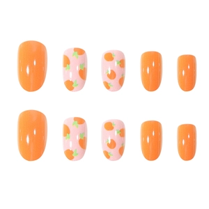 Summer orange press-on nails with cute citrus leaf patterns and vibrant gradient design