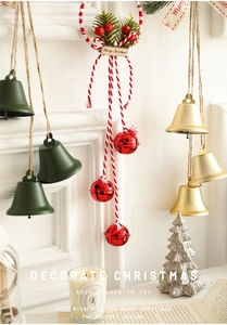 Detail view of festive Christmas bells in red, green and gold with Merry Christmas tag