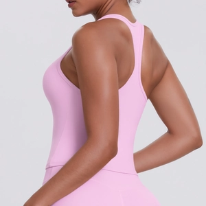 Close-up of racerback detail on a pink moisture-wicking compression yoga sports vest