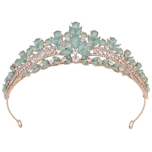 Detailed view of mint green opal crystals and white rhinestones on a gold bridal crown