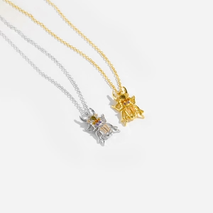 Detailed view of S925 silver beetle pendants in gold and silver with multi-color gems