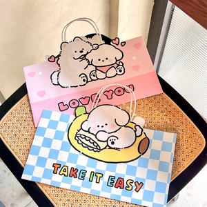 Detail of pink and blue checkered gift bags with cartoon dogs on a rattan chair