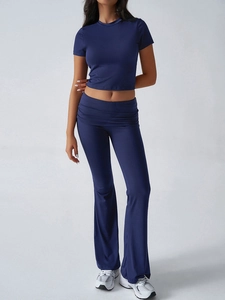 Detail of navy blue slim fit short sleeve crop top and high waist flared pants set