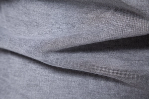 Close-up of high-quality dark gray oxford fabric texture with premium woven detail