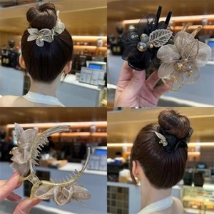 Detail of elegant organza flower hair claw clip with beads in champagne and black