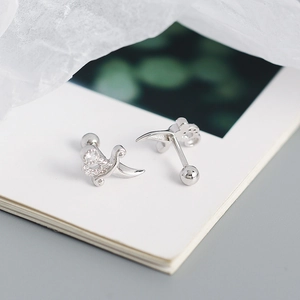 Macro shot of silver dagger stud earrings with cubic zirconia and screw-back details