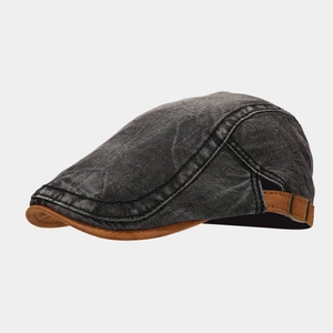 Detail of retro washed denim beret featuring a brown suede brim and adjustable metal buckle