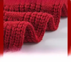 Detail showing high-quality knitted hem of a red scarf with durable lockstitch edges
