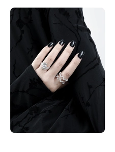 Detail of silver S925 rings with irregular textures and sparkling zircon on model fingers
