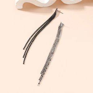 Macro detail of long fringe earrings with three rows of square-cut rhinestones
