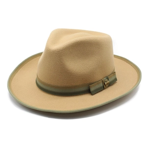 Detail of camel wool fedora hat featuring green striped ribbon and gold buckle accent