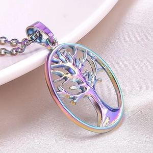 Macro shot of a rainbow-plated Tree of Life oval pendant with a cutout metal design