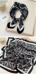 Detail of vintage paisley silk scarf with black and white floral pattern for neck styling
