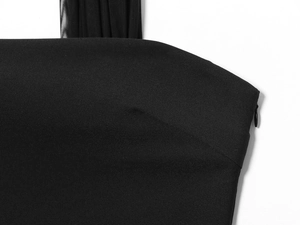 Detail of black dress featuring sheer pleated straps and a discreet side invisible zipper