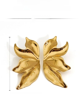 Macro view of gold leaf-shaped earrings with 53mm height and 26mm width details