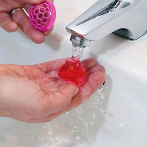 Reusable pink sticky cleaning ball for handbags and purses inside dust dirt removal