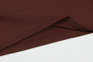 Detail of double-needle stitching and flat seams on burgundy side-slit maxi dress