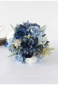 Close-up of blue and white artificial wedding bouquet with silk roses and berries